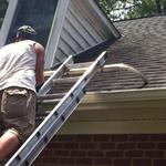 A technician repairing a gutter with Hidden Hangers